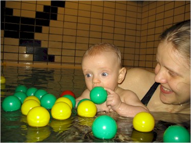 There was a basket of little balls like these, and although Molli seemed content to play with one at a time, her old man thought it would be more fun, and more photographically colorful, to dump them all into the pool at once.  Molli came around to dad's way of thinking pretty quickly.